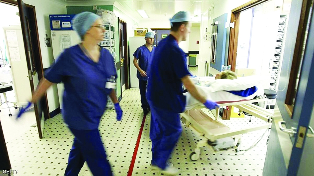 BIRMINGHAM, UNITED KINGDOM - JUNE 14: Theatre staff at The Queen Elizabeth Hospital Birmingham take a patient into recovery after an operation on June 14, 2006 in Birmingham, England. Senior managers of the NHS have said that the organisation needs to become more open in the future. (Photo by Christopher Furlong/Getty Images)