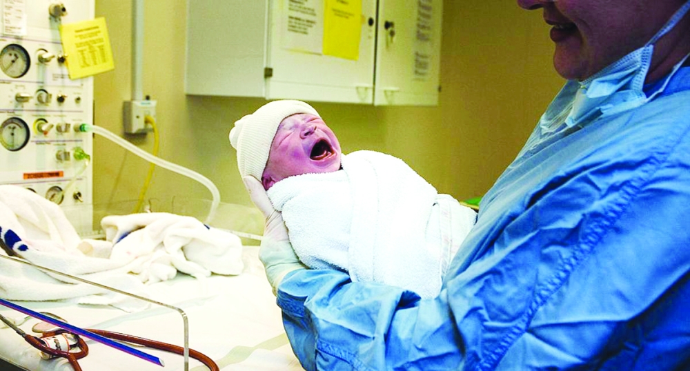 KNUTSFORD, UNITED KINGDOM - (FILE) In this file photograph dated March 6, 2007, a young boy is weighed after being born in an NHS maternity unit, in Manchester, England. Health Secretary Patricia Hewitt announnced, April 3, 2007 that for the first time, mothers-to-be will have a guarantee that the NHS will provide them with a full range of birthing choices - including home births - and a midwife they know and trust to care for them. (Photo by Christopher Furlong/Getty Images)