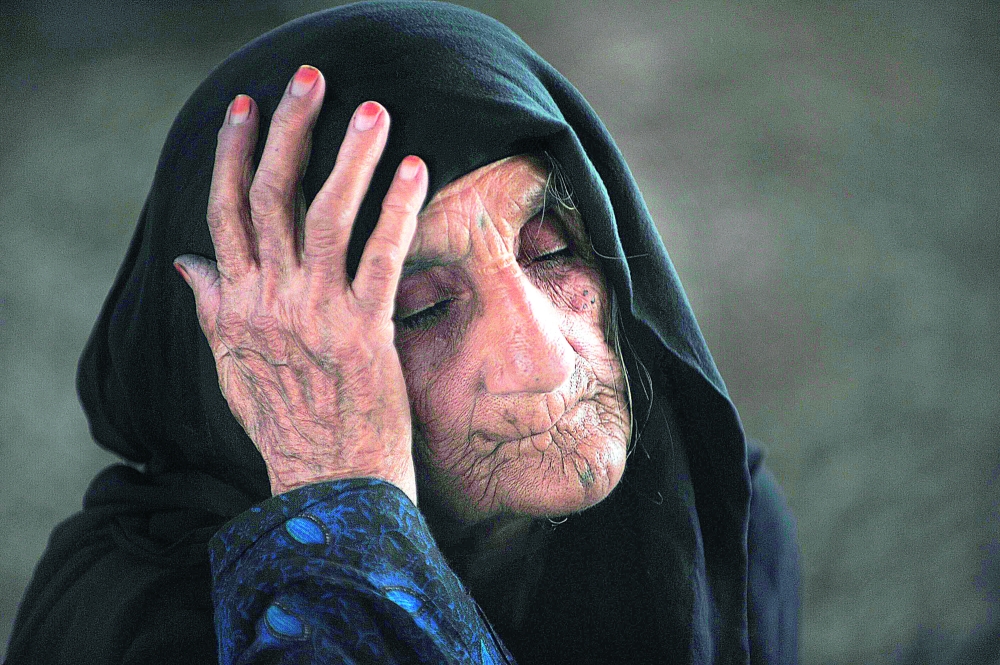 An Afghan refugee waits at the United Nations High Commissioner for Refugees (UNHCR) registration center on the outskirts of Peshawar on June 7, 2010 prior to returning to their home country Afghanistan. About 1.7 million Afghan refugees remain in Pakistan after fleeing civil war and Taliban rule in their homeland. AFP PHOTO/ A. MAJEED