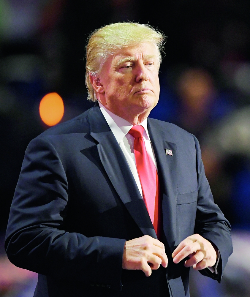 Republican Presidential Candidate Donald Trump straightens his jacket after taking the stage during the final day of the Republican National Convention in Cleveland, Thursday, July 21, 2016. (AP Photo/Mark J. Terrill)