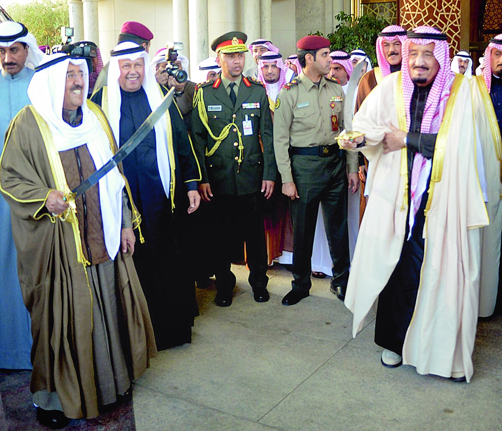 A handout picture released by the Emir of Diwan shows the Emir of Kuwait Sheikh Sabah al-Ahmad al-Sabah (L) and Saudi King Salman bin Abdulaziz al-Saud (R) doing the traditional al-Ardha dance at the Bayan Palace following the Saudi king's arrival in Kuwait City on December 8, 2016.  - RESTRICTED TO EDITORIAL USE - MANDATORY CREDIT 