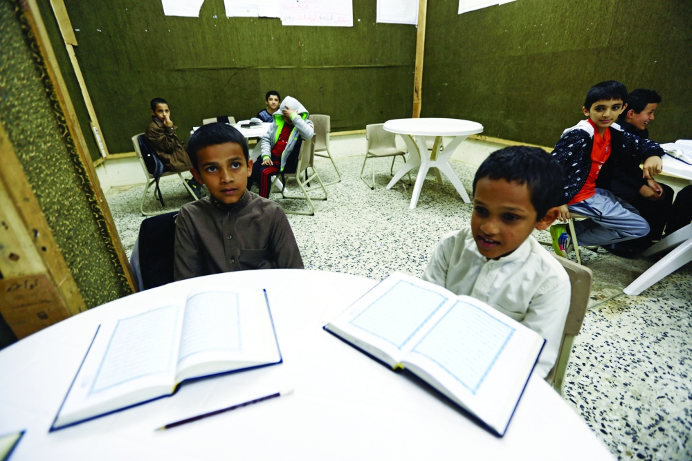 Saudi brothers of al-Fefi family attend a Koran class after making their way to their school through Fifa Mountain, in Jazan, south of Saudi Arabia, December 15, 2016. Picture take December 15, 2016. REUTERS/Mohamed Al Hwaity