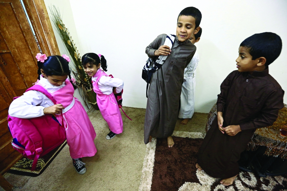 Saudi children of al-Fefi family prepare themselves before they go to their school through Fifa Mountain, in Jazan, south of Saudi Arabia, December 15, 2016. Picture take December 15, 2016. REUTERS/Mohamed Al Hwaity