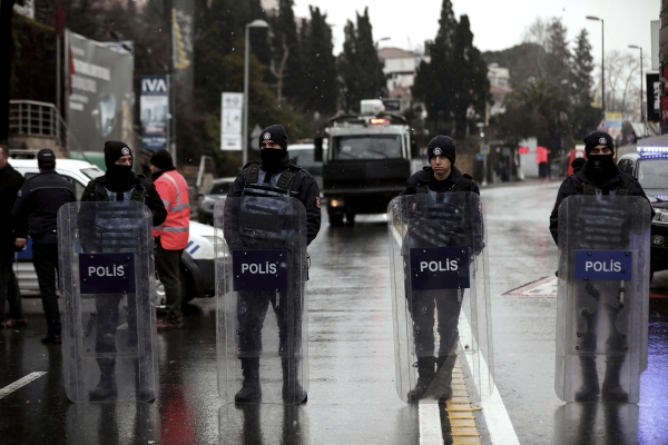 Turkish police officers block the road leading to the scene of an attack in Istanbul, early Sunday, Jan. 1, 2017. An assailant believed to have been dressed in a Santa Claus costume opened fire at a crowded nightclub in Istanbul during New Year's celebrations, killing dozens of people and wounding close to dozens of others in what the province's governor described as a terror attack. (AP Photo/Halit Onur Sandal)