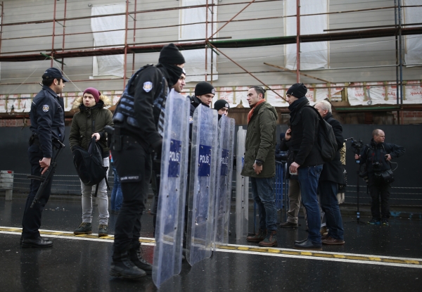 Turkish police officers block the road leading to the scene of an attack in Istanbul, early Sunday, Jan. 1, 2017. An assailant believed to have been dressed in a Santa Claus costume opened fire at a crowded nightclub in Istanbul during New Year's celebrations, killing dozens of people and wounding tens of others in what the province's governor described as a terror attack. (AP Photo/Emrah Gurel)