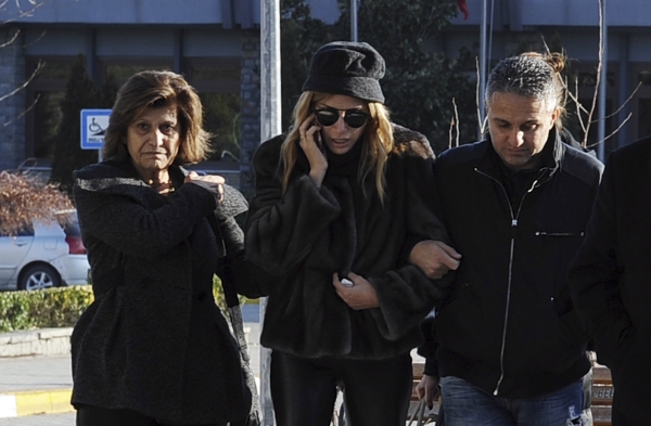 Lebanese Mireille Musalam, center, who lost her husband Haikal Musalam, walks outside a morgue a day after an attack at a popular nightclub in Istanbul, Monday, Jan. 2, 2017. A manhunt is on in Turkey as authorities work to identify the assailant who killed dozens of people in a crowded Istanbul nightclub during New Year's celebrations Sunday. (AP Photo/Omer Kuscu)