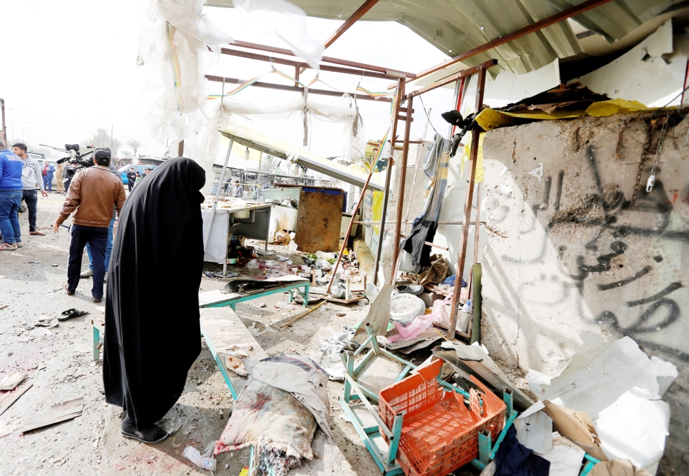 A woman reacts at the site of car bomb attack in a busy square in Baghdad's sprawling Sadr City district, January 2, 2017. REUTERS/Ahmed Saad