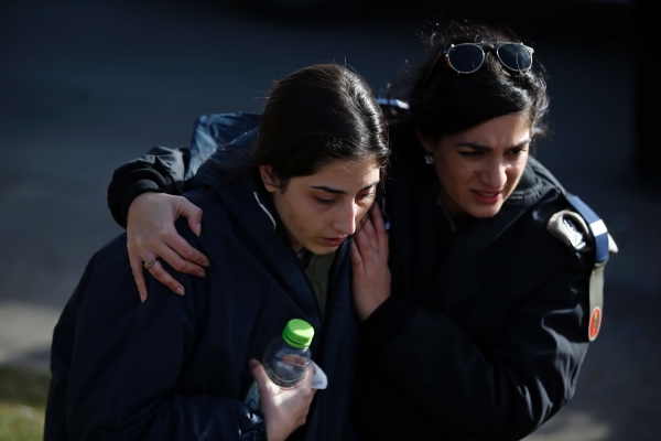 An Israeli soldier is consoled as she cries at the site of a vehicle-ramming attack in Jerusalem on January 8, 2017. A truck ploughed into a group of soldiers in Jerusalem on in which a number of people were injured.

 / AFP / AHMAD GHARABLI
