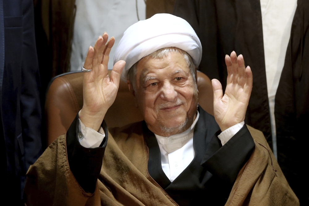 FILE -- In this Dec. 21, 2015 file photo, former Iranian President Akbar Hashemi Rafsanjani waves to journalists as he registers his candidacy for the elections of the Experts Assembly, in Tehran, Iran. Iranian media said Sunday, Jan. 8, 2017, that Rafsanjani, who served as president from 1989 to 1997, has been hospitalized because of a heart condition. The official IRNA news agency reported that Rafsanjani was taken to a public hospital north of the capital, Tehran. (AP Photo/Ebrahim Noroozi, File)