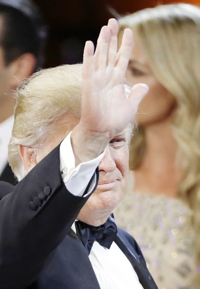 President Donald J. Trump waves as he leaves The Salute To Our Armed Services Inaugural Ball Friday, Jan. 20, 2017, in Washington. (AP Photo/David J. Phillip)