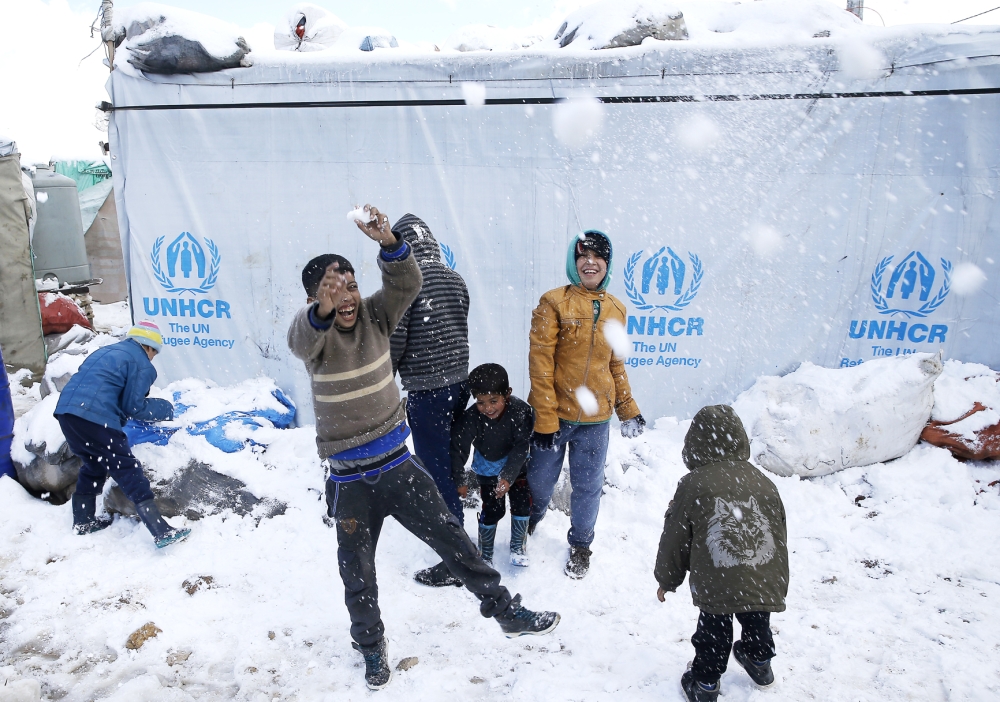 Syrian children play in the snow, at an informal refugee camp in the eastern Lebanese town of Marj near the border with Syria, Lebanon, Saturday, Jan. 28, 2017. In an executive order Friday, Trump suspended all refugee admissions to the U.S. for four months and banned the entry of Syrian refugees indefinitely, pending a security review of the admissions program. (AP Photo/Hussein Malla)