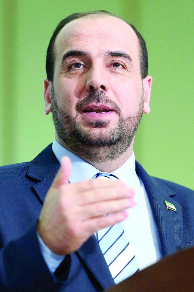 Syria's main opposition High Negotiations Committee (HNC) leader Nasr al-Hariri, informs the media after the round of negotiation between the High Negotiations Committee (HNC) and the UN Special Envoy of the Secretary-General for Syria Staffan de Mistura at the European headquarters of the United Nations in Geneva, Switzerland, Wednesday, March 1, 2017. (Martial Trezzini/Keystone via AP)