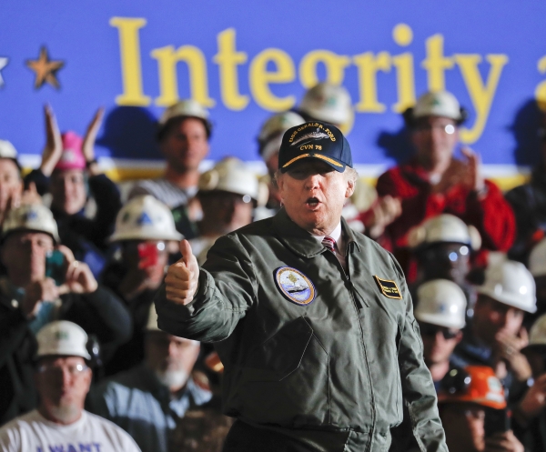 FILE - In this Thursday, March 2, 2017, file photo, President Donald Trump gives a thumbs-up after speaking to Navy and shipyard personnel aboard the nuclear aircraft carrier Gerald R. Ford at Newport News Shipbuilding in Newport News, Va. The ship, which is still under construction, is due to be delivered to the Navy later in the year. The area around the Virginia shipyard where Trump visited is just the kind of place that would likely feel the greatest economic impact from his requested $54 billion increase in defense spending. But outside of that kind of local impact near the shipyards or jet factories receiving additional money, experts say the increased defense spending wouldn't make much difference overall. (AP Photo/Pablo Martinez Monsivais, File)