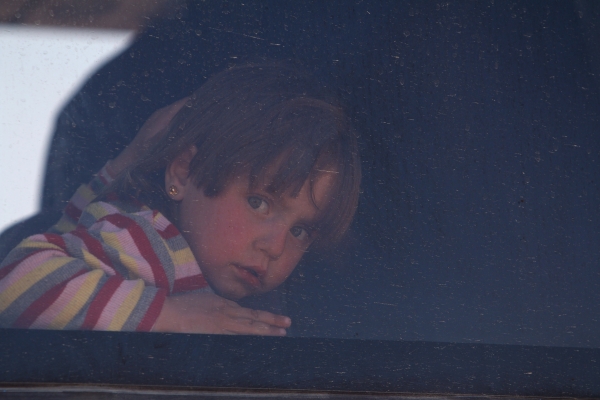 A girl that fled from Raqqa city rides a bus in al-Mahmudli village, west of Raqqa, Syria April 5, 2017. REUTERS/Rodi Said