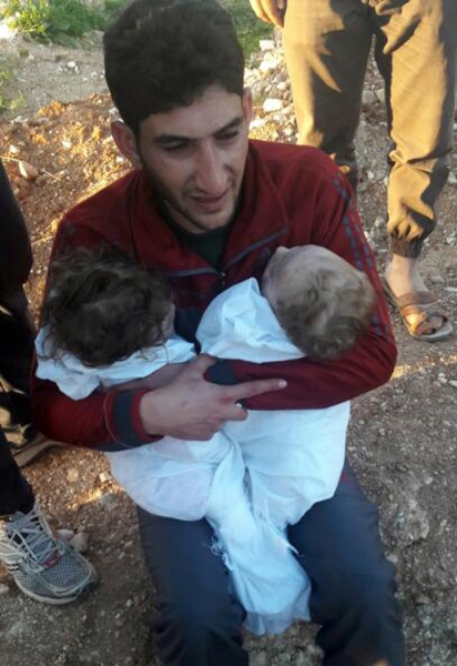 In this picture taken on Tuesday April 4, 2017, Abdul-Hamid Alyousef, 29, cries as he holds his twin babies who were killed during a suspected chemical weapons attack, in Khan Sheikhoun town, in the northern province of Idlib, Syria. Alyousef also lost his wife, two brothers, nephews and many other family members in the attack that claimed scores of his relatives. The death toll from a suspected chemical attack on a northern Syrian town rose to 72 on Wednesday as activists and rescue workers found more terrified survivors hiding in shelters near the site of the harrowing assault, one of the deadliest in Syria's civil war. (Alaa Alyousef via AP)