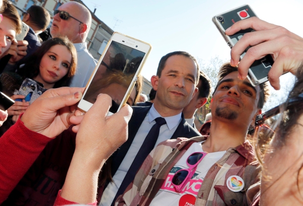 Benoit Hamon, Socialist Party presidential candidate for the 2017 presidential election, makes selfie with supporters after delivering a speech as he campaigns in Carmaux, France, April 21, 2017. REUTERS/Regis Duvignau