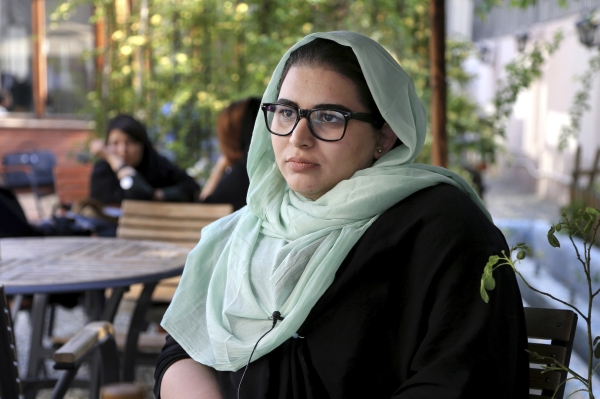 In this April 22, 2017 photo, Shahrzad Ebrahimi, a 22-year-old psychology student, listens to questions during an interview with The Associated Press about U.S. President Donald Trump at a cafe in central Tehran, Iran. She said 