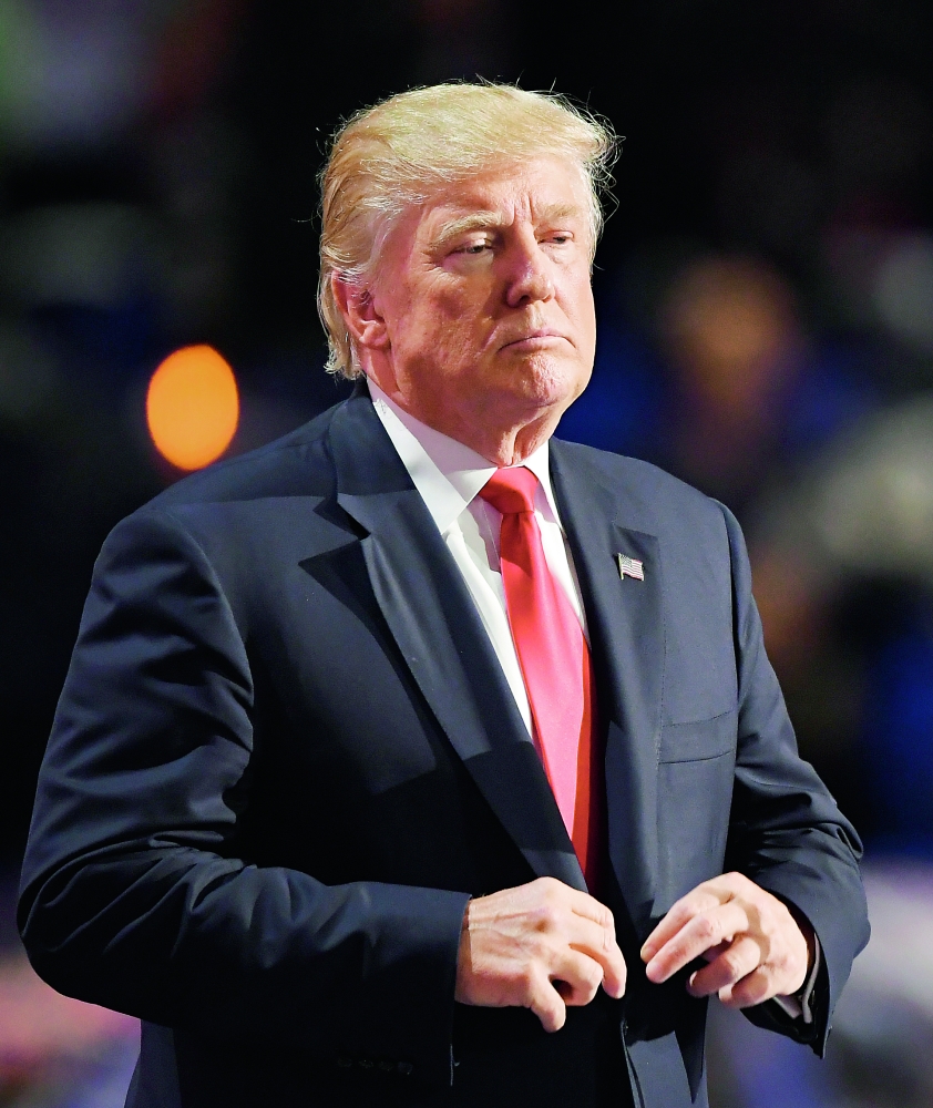 Republican Presidential Candidate Donald Trump straightens his jacket after taking the stage during the final day of the Republican National Convention in Cleveland, Thursday, July 21, 2016. (AP Photo/Mark J. Terrill)