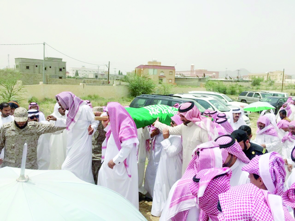 ذوو الشهيد القحطاني أثناء تشييعه إلى مقبرة حي لزمة. (تصوير: خالد آل مريح)