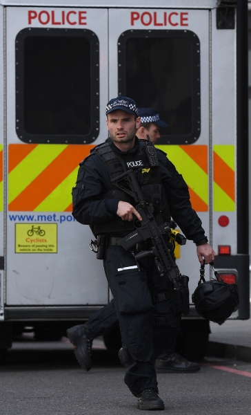 Armed Police officers patrol on Borough High Street in London on June 4, 2017, as police continue their investigations following the June 3 terror attack. Seven people were killed in a terror attack on Saturday by three assailants on London Bridge and in the bustling Borough Market nightlife district, the chief of London's police force said on Sunday. / AFP / Chris J Ratcliffe
