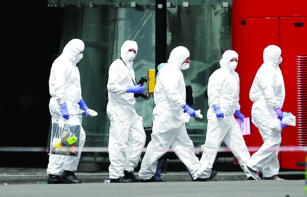 Police forensic investigators work outside Borough Market after an attack left 7 people dead and dozens injured in London, Britain, June 4, 2017. REUTERS/Peter Nicholls