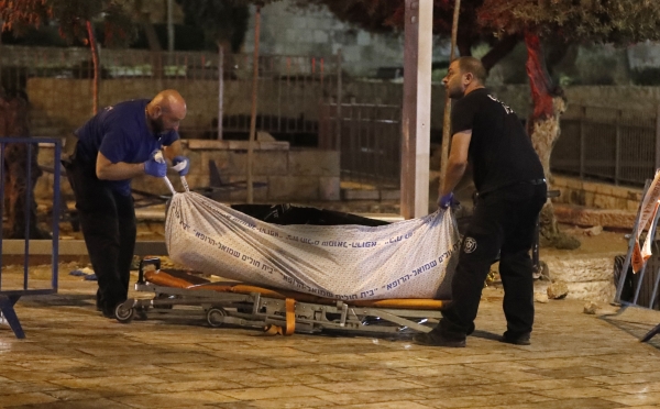 Israeli forensic police remove the bodies suspected Palestinian assailants outside Damascus Gate in Jerusalem's Old City on June 16, 2017 following an attack. An Israeli policewoman was stabbed and critically wounded in the attack, police said, with security forces shooting dead three suspected Palestinian assailants. / AFP / Ahmad GHARABLI
