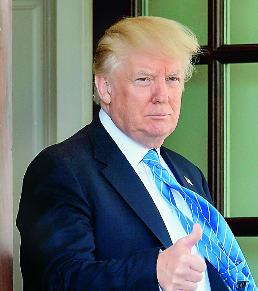 US President Donald Trump gives the thumbs-up as he bids farewell to Palestinian Authority President Mahmud Abbas after meetings at the White House on May 3, 2017 in Washington, DC. / AFP / MANDEL NGAN
