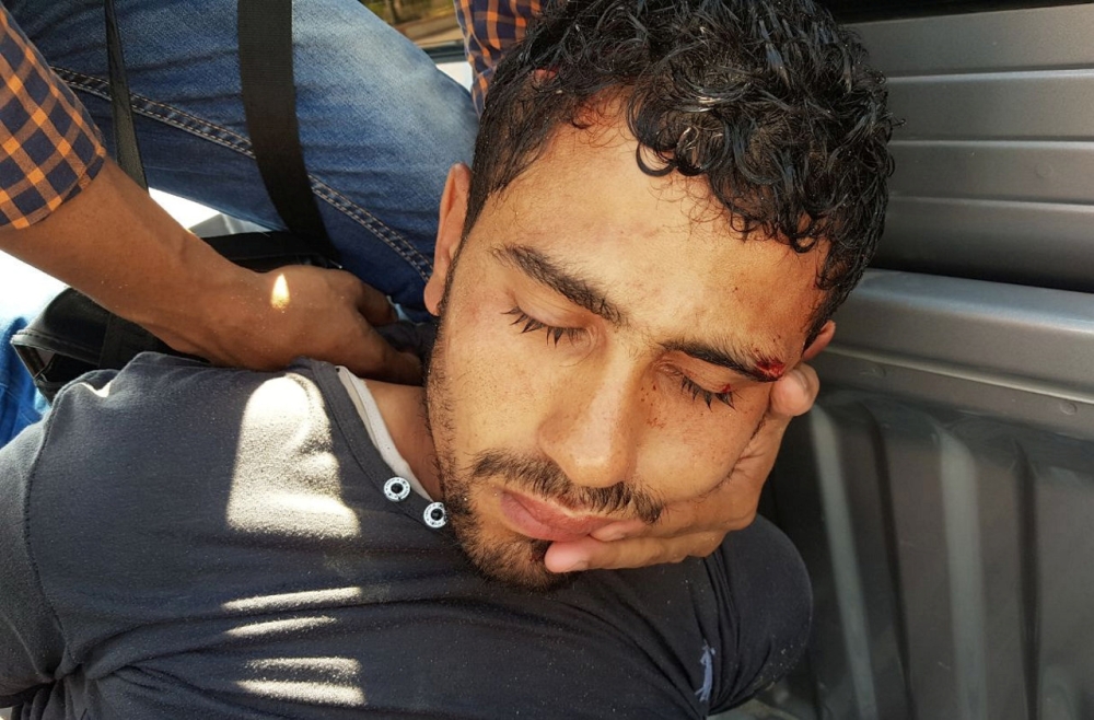 A security personnel detains the man who stabbed two German tourists to death and wounded four others during an attack at the Zahabia hotel resort in Hurghada, south of the capital Cairo, Egypt, July 14, 2017. REUTERS/Mohamed Aly