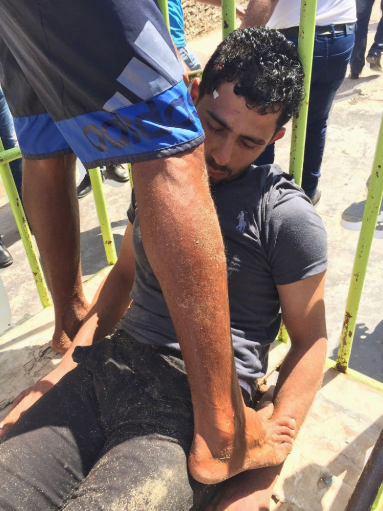 Workers and security personnel detain the man who stabbed two German tourists to death and wounded four others during an attack at the Zahabia hotel resort in Hurghada, south of the capital Cairo, Egypt, July 14, 2017. REUTERS/Mohamed Aly