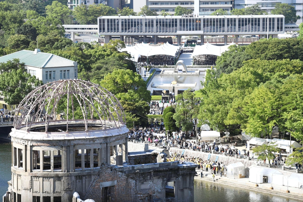 People are seen at the Peace Memorial Park with the Atomic Bomb Dome in the front, at a ceremony in Hiroshima, western Japan, August 6, 2017, on the 72nd anniversary of the atomic bombing of the city. Mandatory credit Kyodo/via REUTERS ATTENTION EDITORS - THIS IMAGE WAS PROVIDED BY A THIRD PARTY. MANDATORY CREDIT. JAPAN OUT. NO COMMERCIAL OR EDITORIAL SALES IN JAPAN.