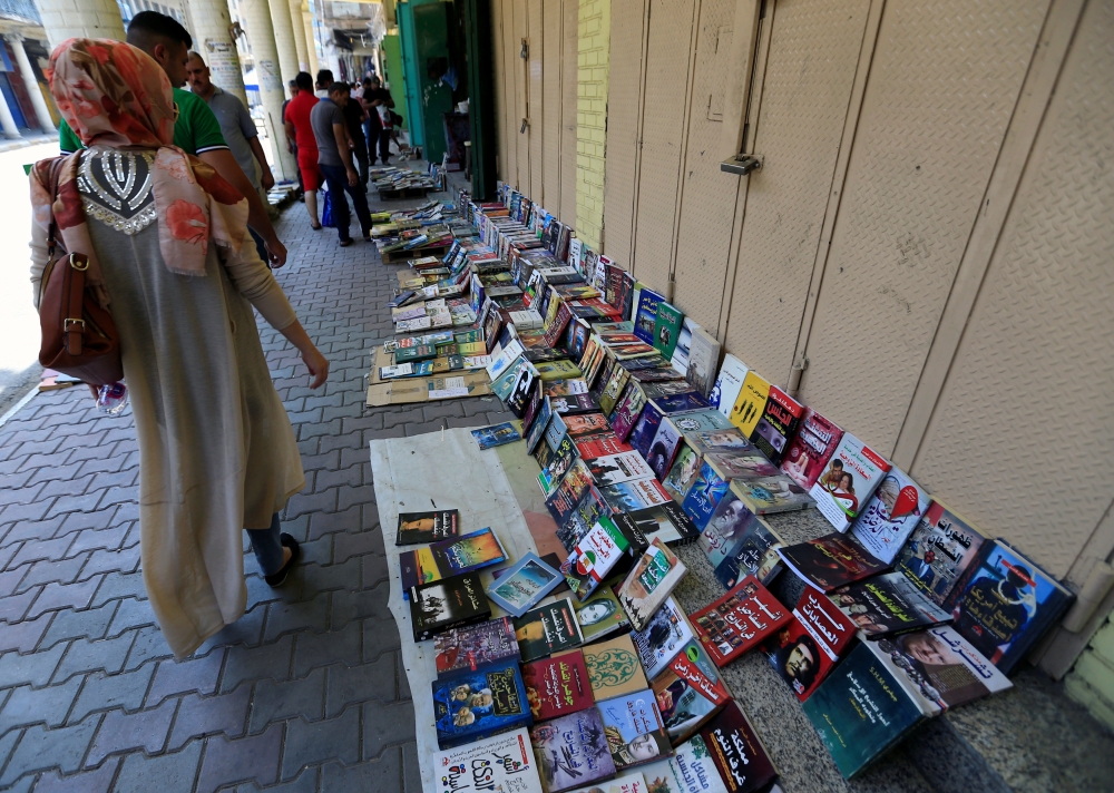 Residents shop for books on Mutanabbi Street in Baghdad, Iraq August 11, 2017. REUTERS/Thaier Al-Sudani