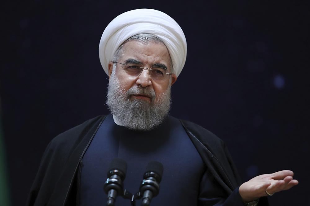 In this photo released by official website of the office of the Iranian Presidency, President Hassan Rouhani, speaks during a ceremony marking National Space Technology Day in Tehran, Iran, Wednesday, Feb. 1, 2017. President Hassan Rouhani has lashed out at the recent executive order by U.S. president Donald Trump to suspend immigration and visa processes for nationals from seven majority-Muslim countries, including Iran. (Iranian Presidency Office via AP)