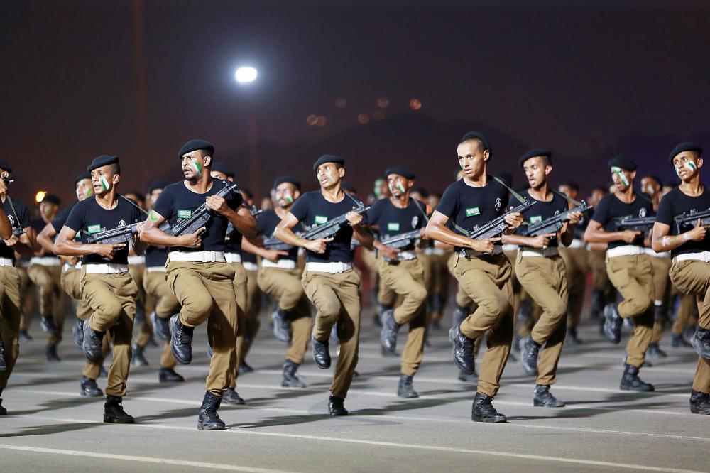 Saudi armed forces march during a parade in Saudi Arabia's holy city of Mecca on August 23, 2017, ahead of the annual Hajj pilgrimage. The hajj to Mecca, the most revered site in Islam, is a pilgrimage that Muslims must perform at least once in their lifetimes if they are able to do so. / AFP / BANDAR ALDANDANI
