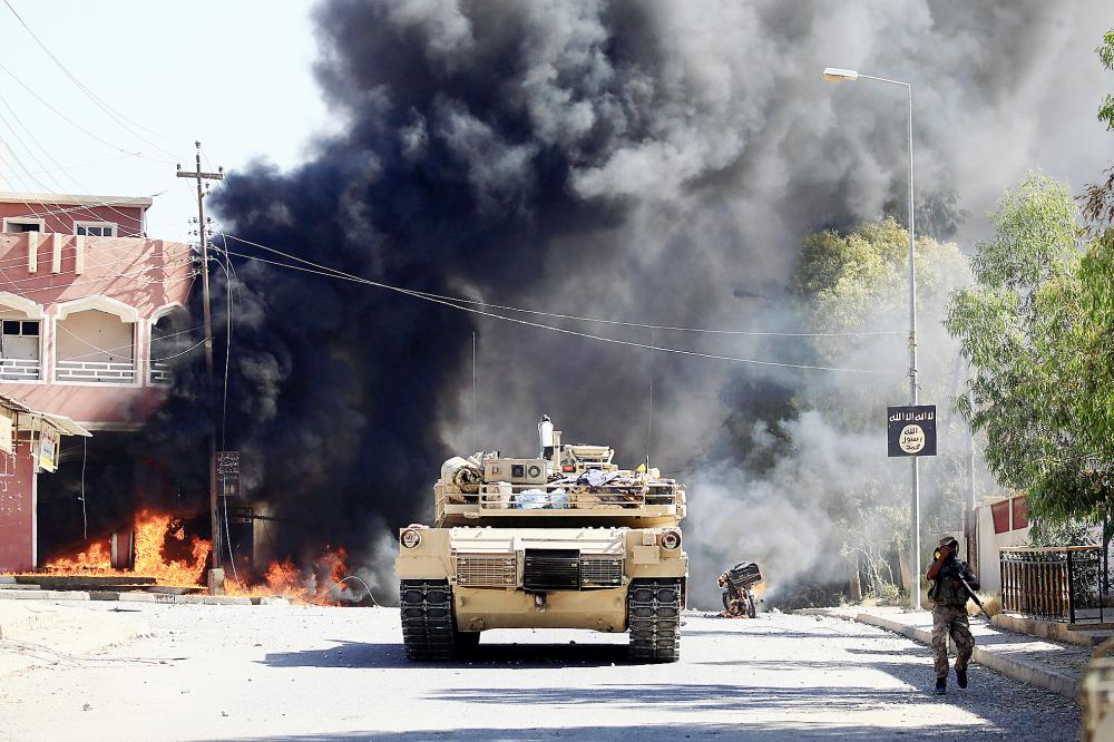 A military vehicle of the Iraqi army with Shi'ite Popular Mobilization Forces (PMF) is seen during a fight with the Islamic State militants in Tal Afar, Iraq August 26, 2017. REUTERS/Thaier Al-Sudani