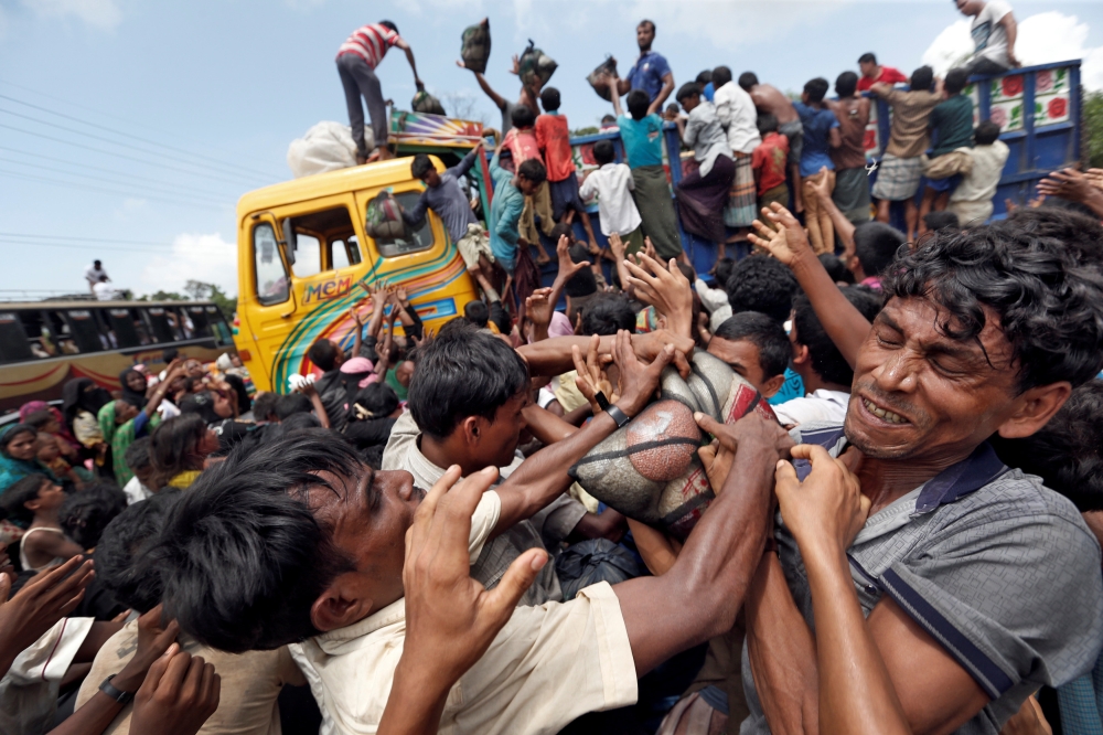 REFILE - CORRECTING TYPO Rohingya refugees scuffle as aid is distributed in Cox's Bazar, Bangladesh, September 23, 2017. REUTERS/Cathal McNaughton