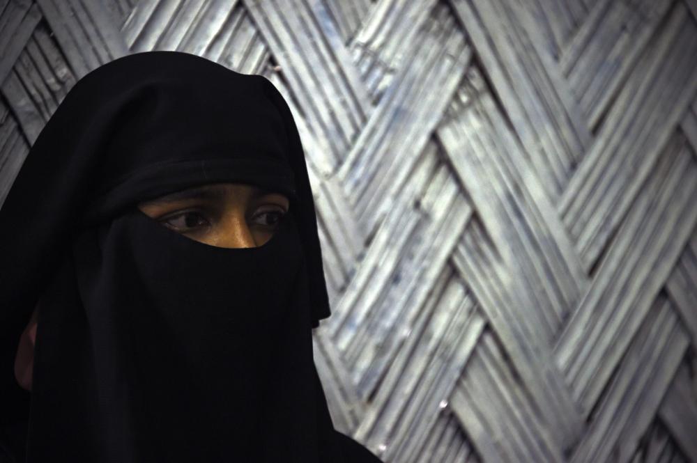 This photograph taken on September 19, 2017 shows Ayesha, a 20-year-old Rohingya refugee victim of rape, talking to reporters at the refugee camp of Leda near Teknaf. Ayesha, came to the clinic in Leda a week after arriving in Bangladesh from Rakhine. When soldiers came to her village in Buthidaung township in northern Rakhine state her neighbours fled. 