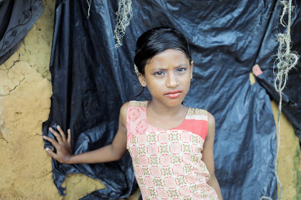 A Rohingya refugee girl poses for a photograph in Kutupalong refugees camp in Cox's Bazar, Bangladesh, October 20, 2017. REUTERS/ Zohra Bensemra