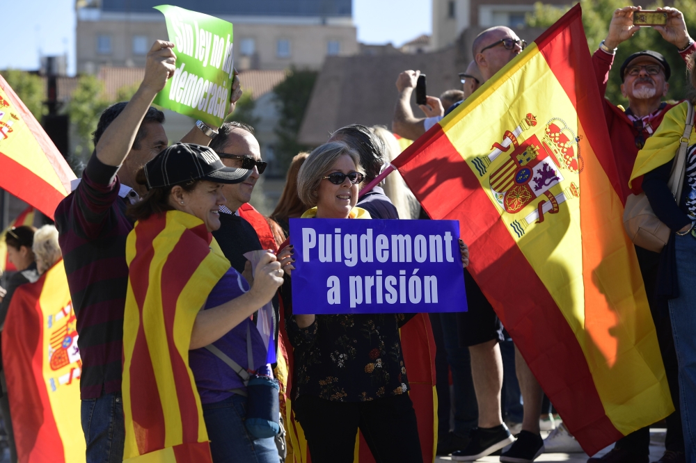 People hold a sign reading 