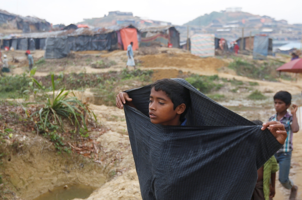 A Rohingya refugee boy walks on a path at Palong Khali refugee camp near Cox's Bazar, Bangladesh October 29, 2017. REUTERS/Adnan Abidi