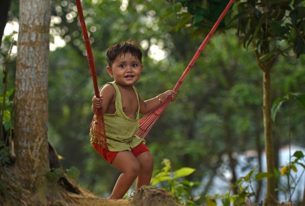 A Rohingya refugee girl plays on a swing outside a makeshift shelter at Moynerghona refugee camp in the Bangladeshi district of Ukhia on October 29, 2017. Bangladesh is planning to introduce voluntary sterilisation in its overcrowded Rohingya camps, where nearly a million refugees are fighting for space, after efforts to encourage birth control failed. More than 600,000 Rohingya have arrived in Bangladesh since a military crackdown in neighbouring Myanmar in August triggered an exodus, straining resources in the impoverished country.
/ AFP / Tauseef MUSTAFA 