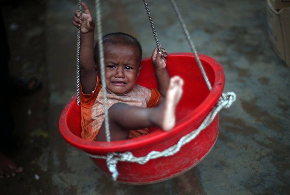 A Rohingya refugee child is weighed at a nutrition centre in Kutupalong refugee camp near Cox's Bazar, Bangladesh, October 29, 2017. REUTERS/Hannah McKay