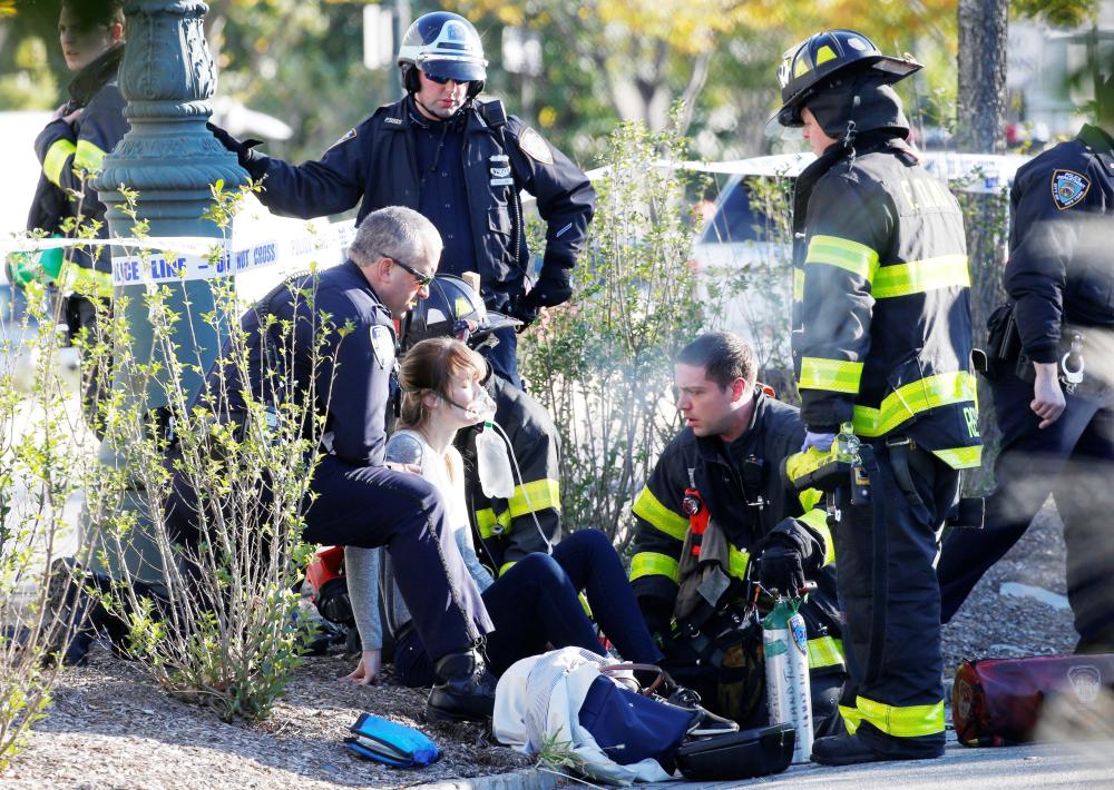 A woman is aided by first responders after sustaining injury on a bike path in lower Manhattan in New York, NY, U.S., October 31, 2017.  REUTERS/Brendan McDermid