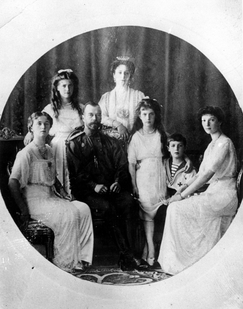 FILE -  Russia's Czar Nicholas II, seated second from left, Czarina Alexandra, center rear, and their family are shown in this undated file photo. Bottom row left to right, Princess Olga, Czar Nicholas II, Princess Anastasia, Prince Alexei and Princess Tatiana. Top row left to right, Princess Maria and Princess Alexandra. The 1917 Bolshevik Revolution was long before the digital revolution allowed anyone to instantly document events. But the clumsy cameras of the time still caught some images that capture the period’s drama. (AP Photo, File)