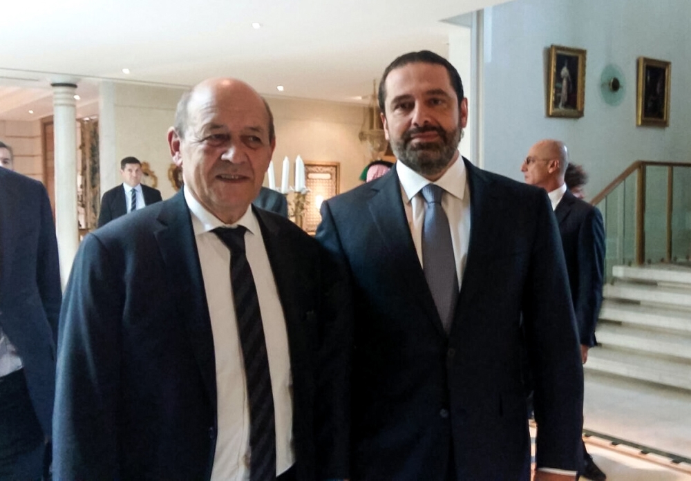 A picture taken with a cell-phone on November 16, 2017, shows French Foreign Minister Jean-Yves Le Drian posing for a photo with Lebanese Prime Minister Saad Hariri in the Saudi capital Riyadh.  / AFP / Valérie LEROUX
