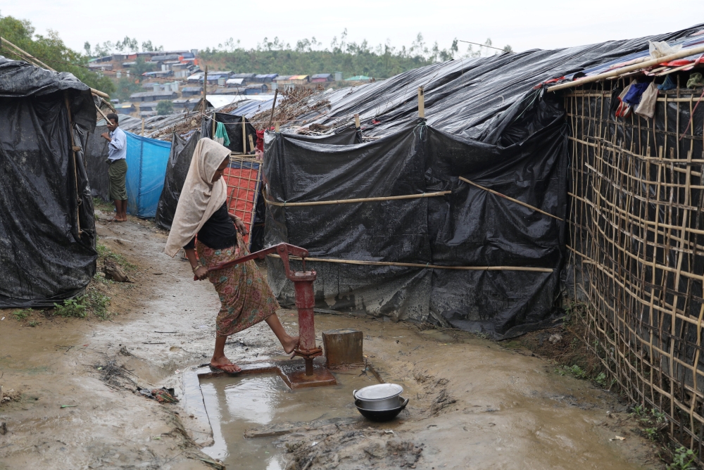 A Rohingya refugee woman washes her legs in a tube-well in the Palong Khali refugee camp in Cox's Bazar, Bangladesh, November 17, 2017. REUTERS/Mohammad Ponir Hossain