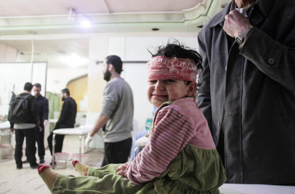 An injured Syrian child sits at a makeshift clinic following reported shelling by Syrian government forces, in the rebel-held town of Douma in Syria's eastern Ghouta region, on November 17, 2017. Shelling by the Syrian regime on the rebel-held Eastern Ghouta, which has been besieged since 2013 and where humanitarian conditions are dire, killed at least 10 civilians, among them six children, the Syrian Observatory for Human Rights said.
The deaths were the result of the latest bout in an escalating cycle of tit-for-tat attacks between regime forces and the rebels holding the enclave on the Syrian capital's eastern outskirts. / AFP / Hamza Al-Ajweh
