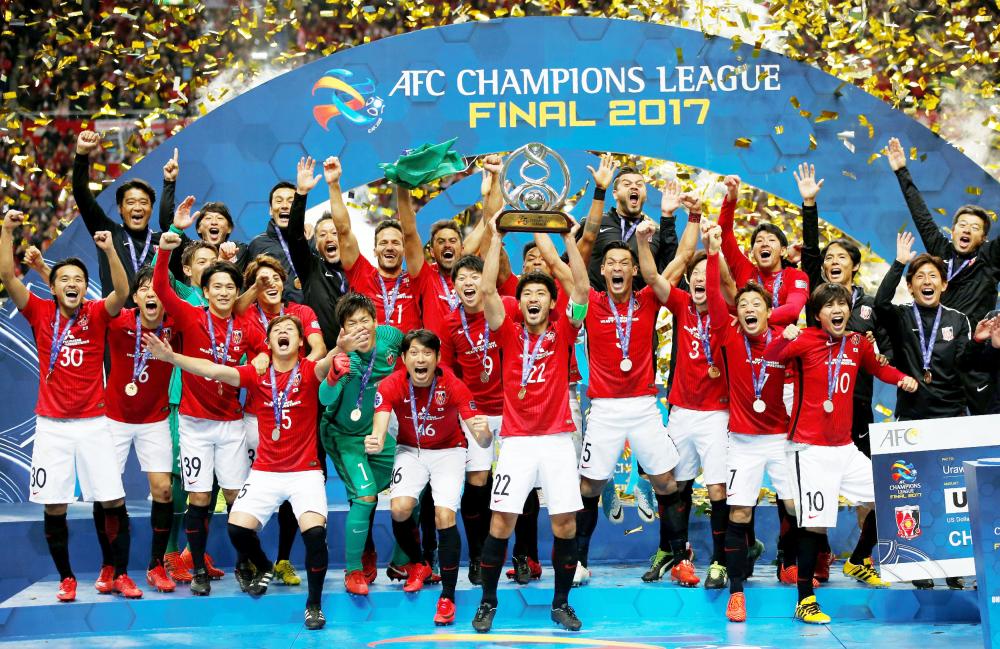 Soccer Football - Japan's Urawa Red Diamonds v Saudi Arabia's Al Hilal - AFC Champions League final, second leg - Saitama Stadium 2002, Saitama, Japan - November 25, 2017. Urawa Red Diamonds' players celebrate on the podium. REUTERS/Toru Hanai