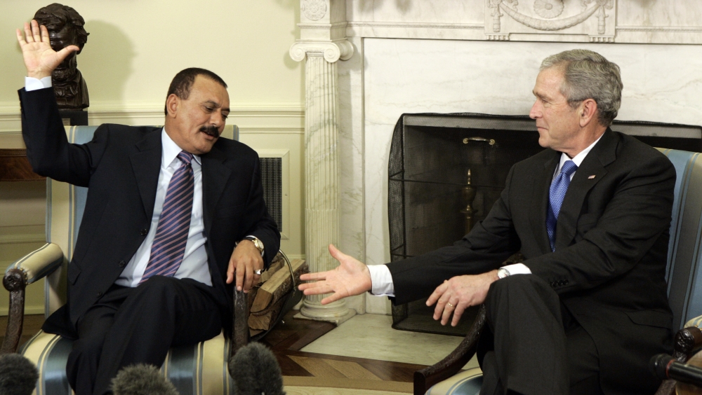 FILE - In this May 2, 2007 file photo, then Yemeni President Ali Abdullah Saleh, left, raises his hands to shake then President Bush's hand in the Oval Office at the White House in Washington. Saleh was killed Monday, Dec. 4, 2017, by Shiite rebels with whom he had once been allied. It was a grisly end for a leader who ruled for more than 30 years by shifting alliances and playing multiple sides in the many conflicts that plagued his impoverished nation. Even after his ouster in 2012, he remained a power player driving the civil war that has brought Yemen to ruinous collapse. (AP Photo/Charles Dharapak, File)