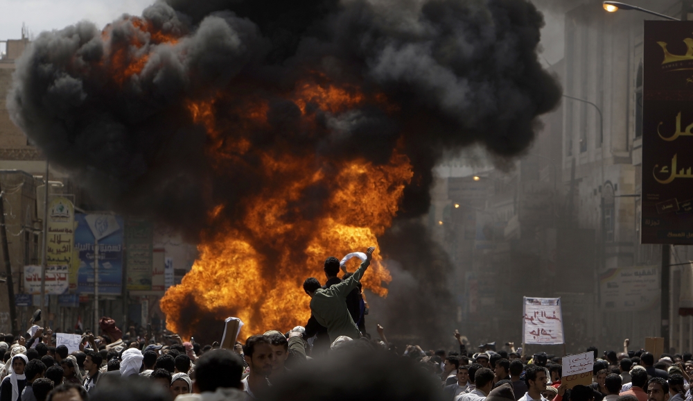 FILE In this, Feb. 22, 2011 file photo, Yemeni anti-government demonstrators react after setting on fire a vehicle belonging to supporters of President Ali Abdullah Saleh during clashes in Sanaa, Yemen. Saleh was killed Monday, Dec. 4, 2017, by Shiite rebels with whom he had once been allied. It was a grisly end for a leader who ruled for more than 30 years by shifting alliances and playing multiple sides in the many conflicts that plagued his impoverished nation. Even after his ouster in 2012, he remained a power player driving the civil war that has brought Yemen to ruinous collapse. (AP Photo/Muhammed Muheisen, File)