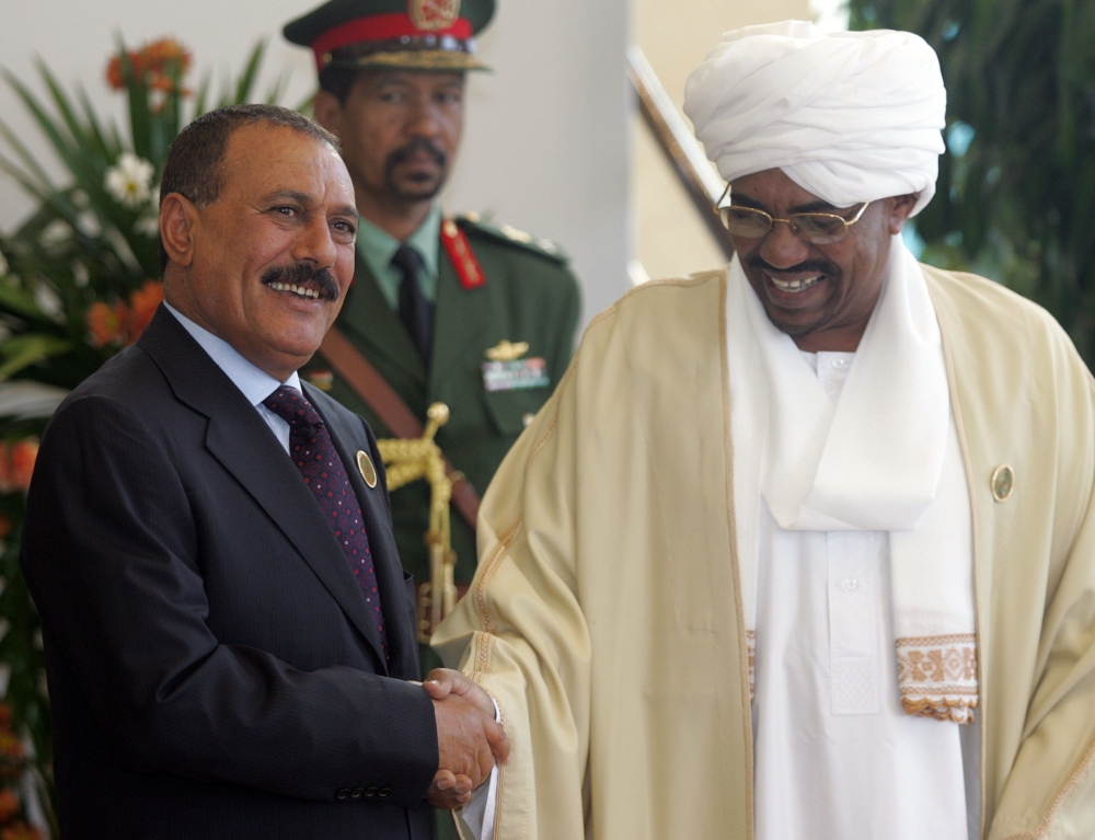 (FILES) This file photo taken on March 28, 2006 shows Yemeni ex-president Ali Abdullah Saleh (L) shaking hands with Sudanese President Omar al-Beshir before the opening session session of the annual Arab summit in Khartoum. Yemen's rebel-controlled interior ministry announced on December 4, 2017 the 